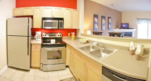 a kitchen with stainless steel appliances and a sink at Chester Village Green Apartments, Chester