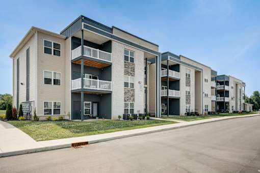 A row of modern apartment buildings with balconies and doors.