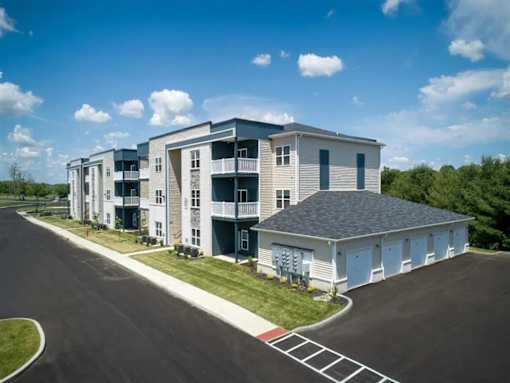 A large apartment complex with multiple buildings and a parking lot.
