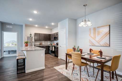A modern kitchen with a dining table set for four.