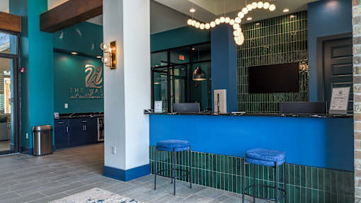 A blue bar with a white column and a TV mounted on the wall.