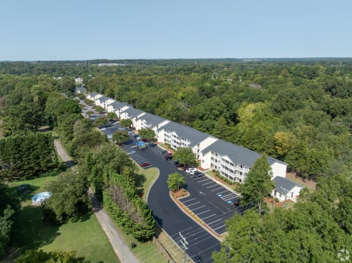 an aerial view of a hotel and parking lot
