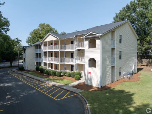 exterior view of an apartment building with white siding and balconies