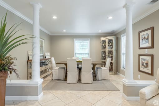 a formal dining room with a large table and chairs