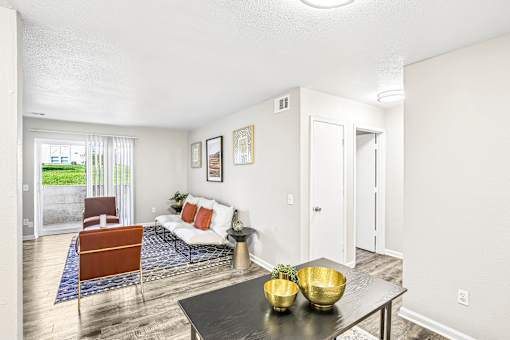 A living room with a white couch and a black coffee table.