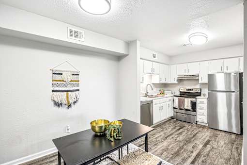 A kitchen with a table and a bowl on it.