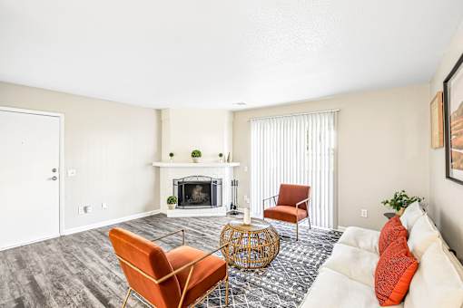 A living room with a fireplace and a chair.