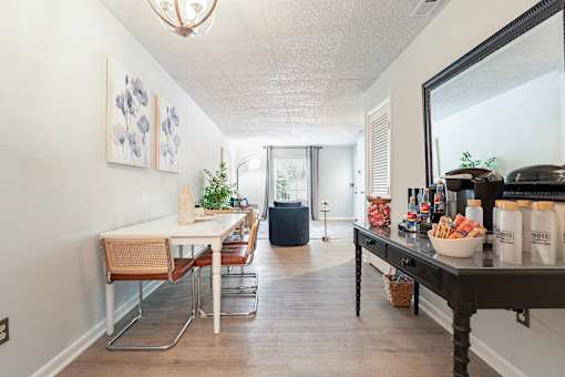 A dining room with a table and chairs.