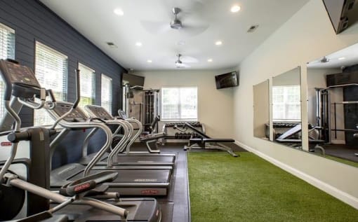 Fitness center with cardio equipment at Oasis at Cedar Branch in Wilmington, NC