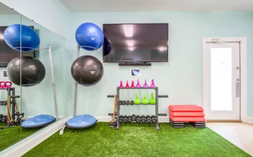 Free weights in fitness center at Oasis at Twinwood in Wilmington, NC