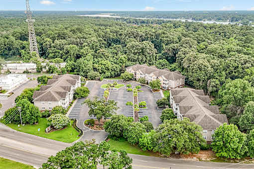 A bird's eye view of a residential area with houses and a road.