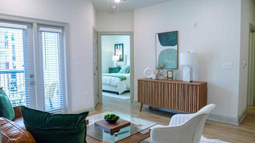 A living room with a white couch and a wooden cabinet.