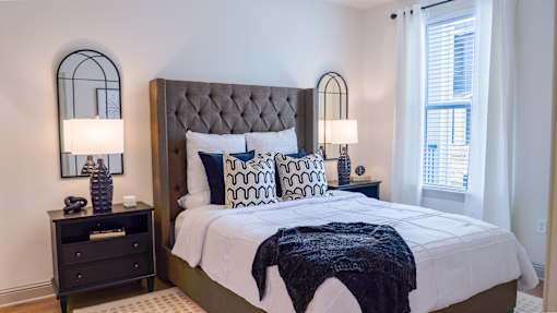 A bedroom with a large bed and a window.
