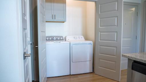 A white dishwasher and washing machine in a kitchen.