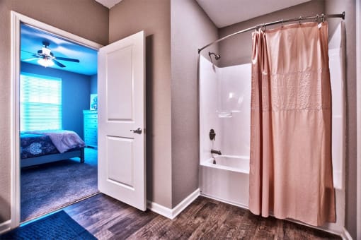 a bathroom with a shower and a bed in a room at Park 33, Goshen