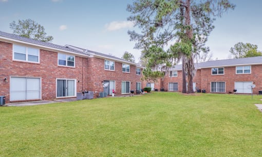 a large yard in front of a brick apartment building at Savan Pointe Townhomes East and West, Georgia, 31406