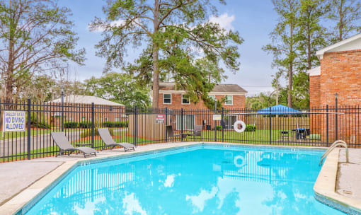 our apartments have a swimming pool with a black fence at Savan Pointe Townhomes East and West, Savannah, 31406