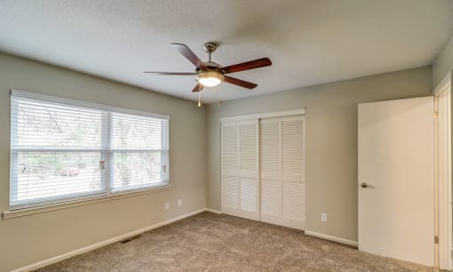 an empty living room with a ceiling fan and a window at Savan Pointe Townhomes East and West, Georgia