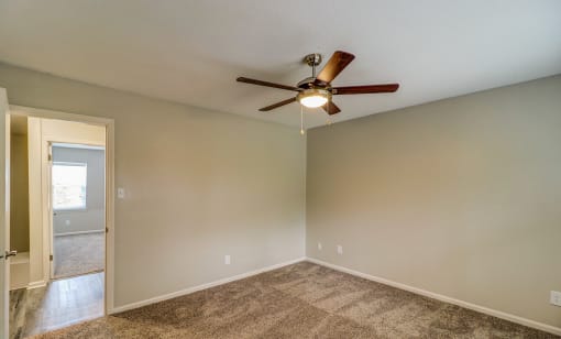 an empty living room with a ceiling fan at Savan Pointe Townhomes East and West, Georgia, 31406