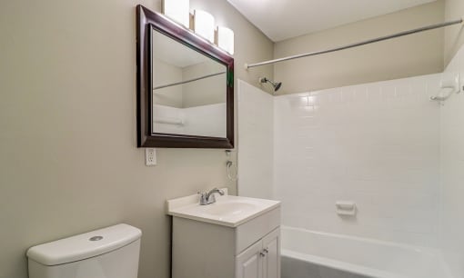 a bathroom with a sink and a mirror and a toilet at Savan Pointe Townhomes East and West, Savannah, 31406