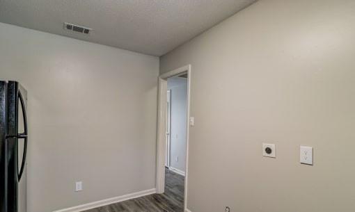 the living room of an empty apartment with a door to the hallway at Savan Pointe Townhomes East and West, Georgia, 31406