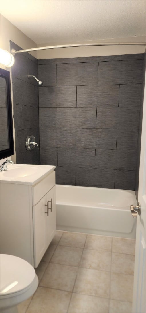 a bathroom with a sink toilet and a bath tub at Savan Pointe Townhomes East and West, Savannah, 31406