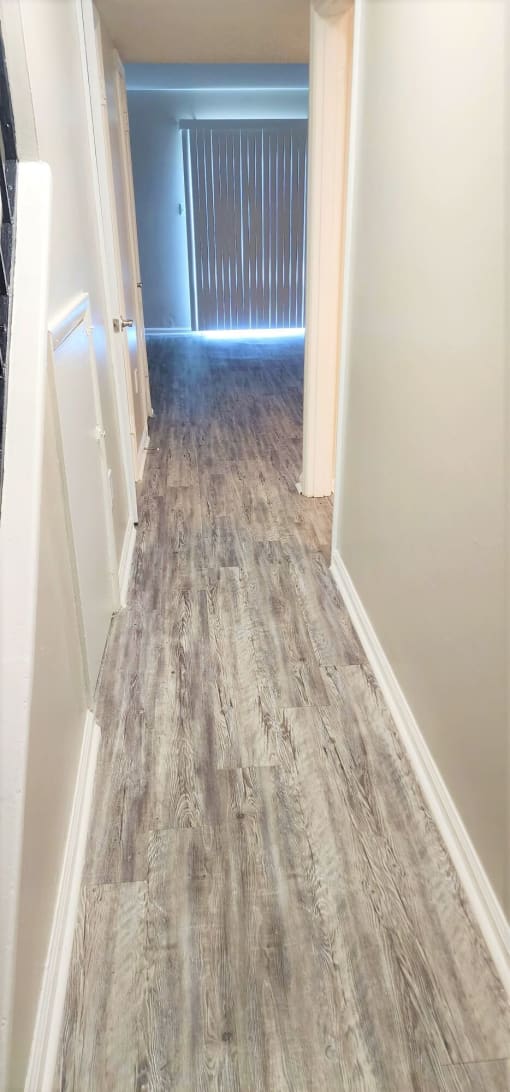 a hallway with a hard wood floor and a closet at Savan Pointe Townhomes East and West, Georgia