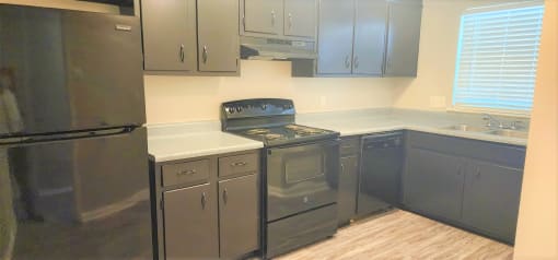 a kitchen with stainless steel appliances and white counter tops at Savan Pointe Townhomes East and West, Savannah, GA