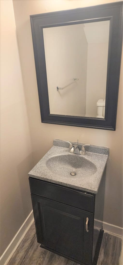 a bathroom with a sink and a mirror at Savan Pointe Townhomes East and West, Savannah