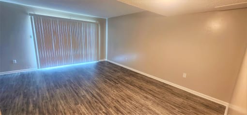 an empty living room with wood flooring and a window at Savan Pointe Townhomes East and West, Savannah, 31406 