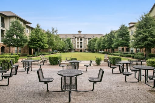 an empty patio at an event with tables and chairs