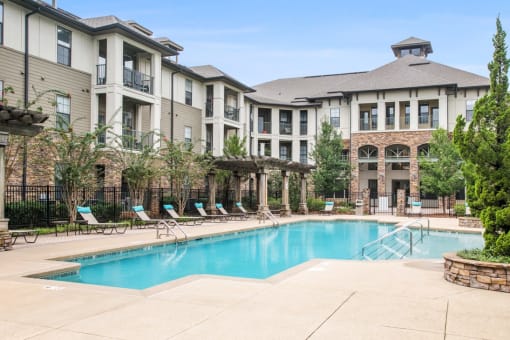 a swimming pool with a building in the background