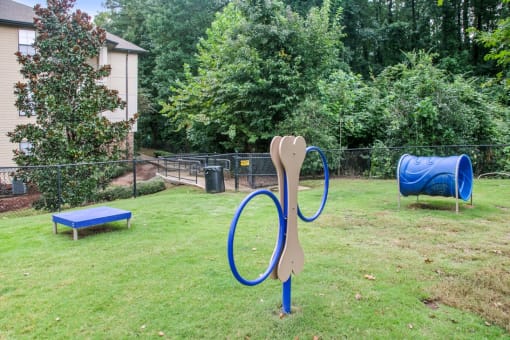 a playground with a blue slide and a rocking horse