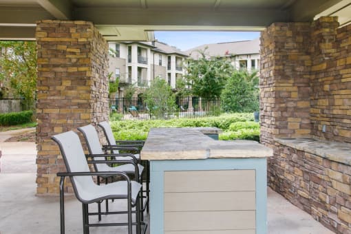 a bar with chairs and a table on a patio