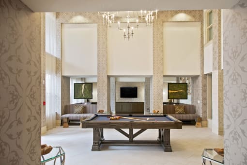 a living room with a pool table and a fireplace
