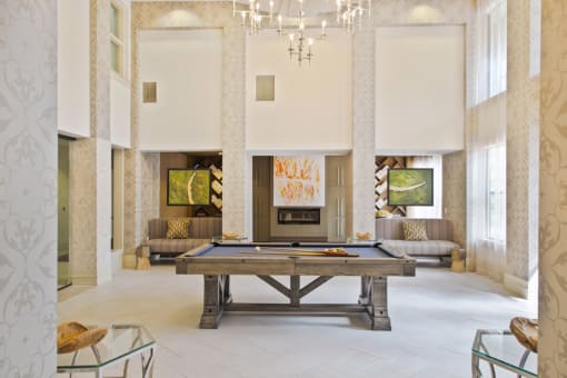 a large living room with a pool table and a fireplace