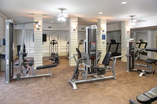 a gym with weights and other exercise equipment in a building