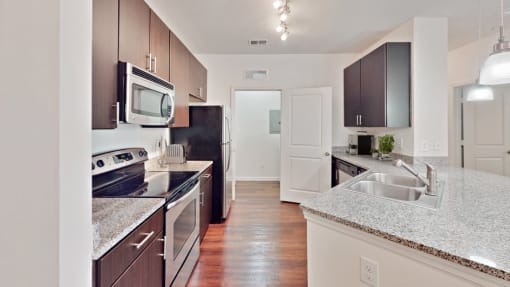 a modern kitchen with granite counter tops and stainless steel appliances