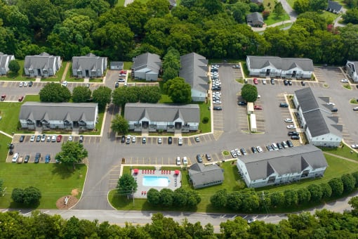 an aerial view of a parking lot with several buildings and a poolat The Dylan, Murfreesboro Tennessee