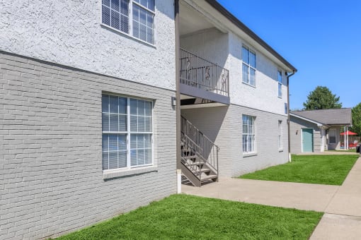 a side by side view of a white brick apartment building at The Dylan, Murfreesboro, TN 37129 
