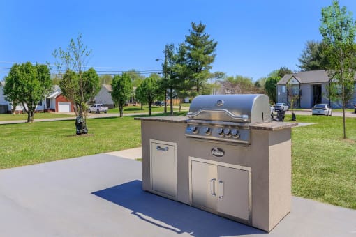 a stainless steel barbecue grill in the middle of a sidewalk at The Dylan, Murfreesboro, TN
