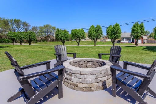 a fire pit with chairs and trees in a park at The Dylan, Murfreesboro, TN 37129