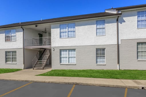 an exterior view of a white brick apartment building with a staircase at The Dylan, Murfreesboro, TN 