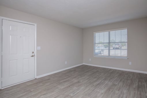 an empty bedroom with a door and a window at The Dylan, Murfreesboro, 37129