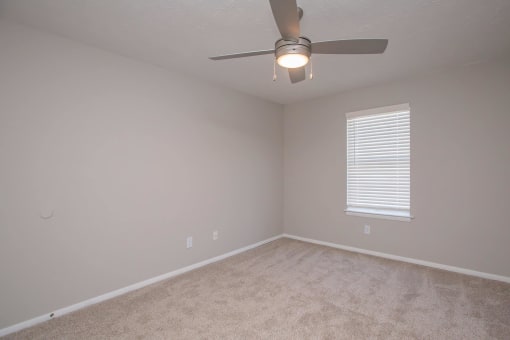 a bedroom with a ceiling fan and a window at The Dylan, Tennessee, 37129