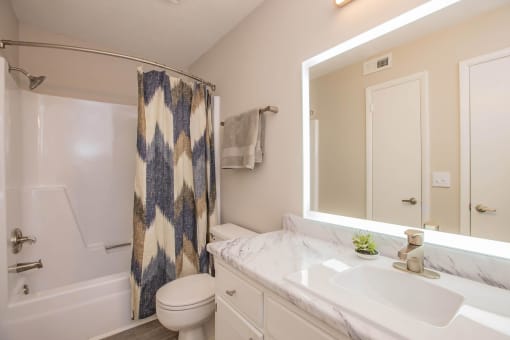 a bathroom with a sink and a toilet and a shower at The Dylan, Murfreesboro, TN