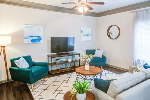 a living room with a couch and a tv at Century HomePlace, Alabama