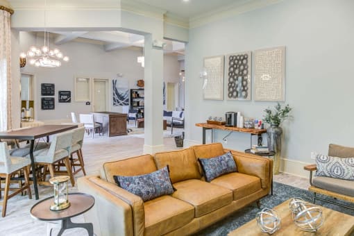 a living room and dining room with a couch and a table at Century HomePlace, Prattville, AL