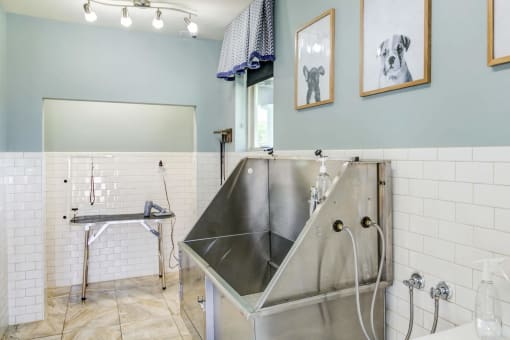a large stainless steel sink in a bathroom with a shower at Century HomePlace, Prattville Alabama