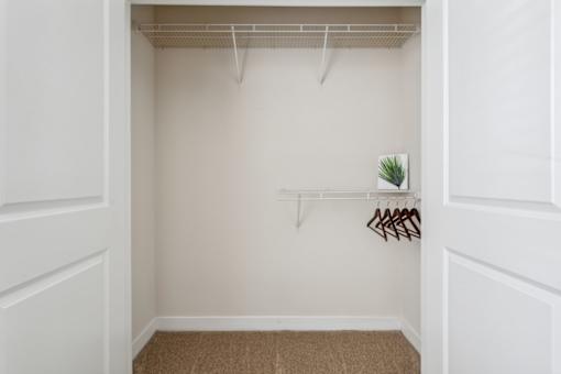 A small closet with a shelf and a plant.at Century Hampton Roads, Suffolk, VA  